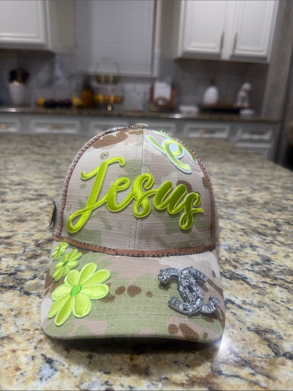 Camouflage Baseball Cap with Neon Green 'Jesus' Script and Floral Accents